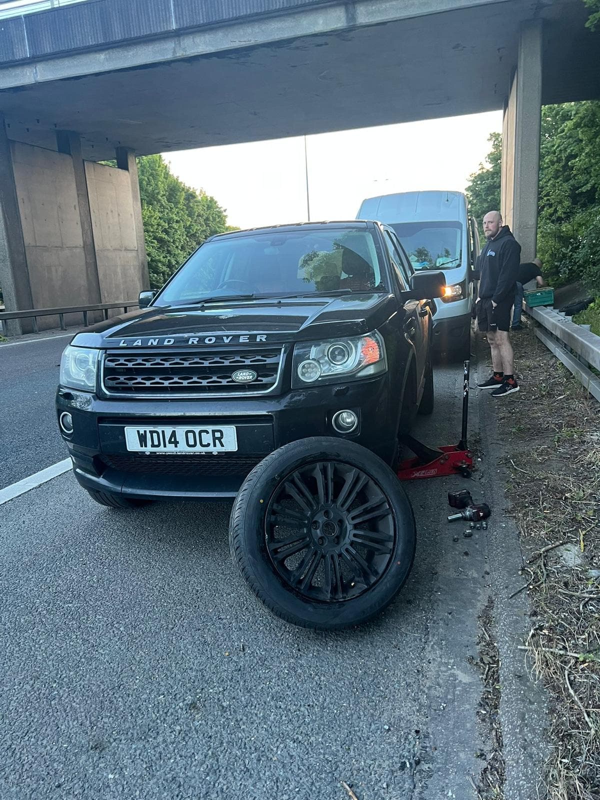 Roadside mobile tyre call-out with a wheel removed and replacement tyre ready to fit